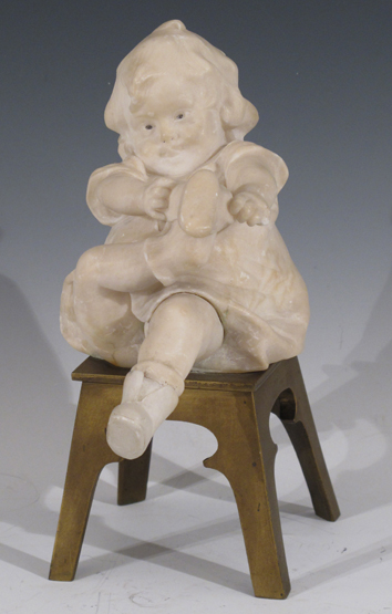 ‡Juan Clara Ayats (Spanish 1875-1958) A seated child putting on shoes Signed on bronze chair