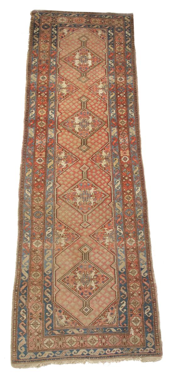 A Kurdish runner, north west Persia, early 20th century, 124.5 x 41in (316 x 104 cm).