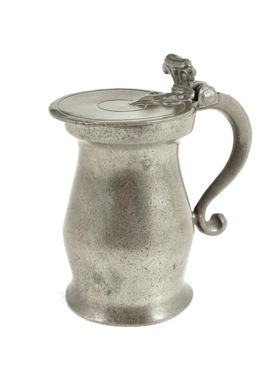 An 18th century pewter double volute lidded pint measure, maker`s mark worn, but probably `TS`, c.