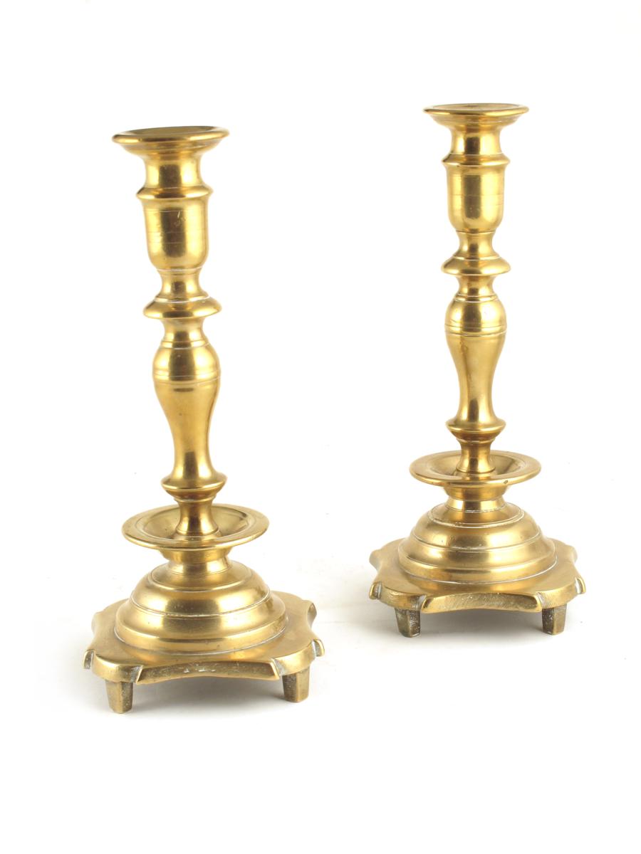 A pair of North European bell metal candlesticks, on rod feet, late 17th / early 18th century, 10½in