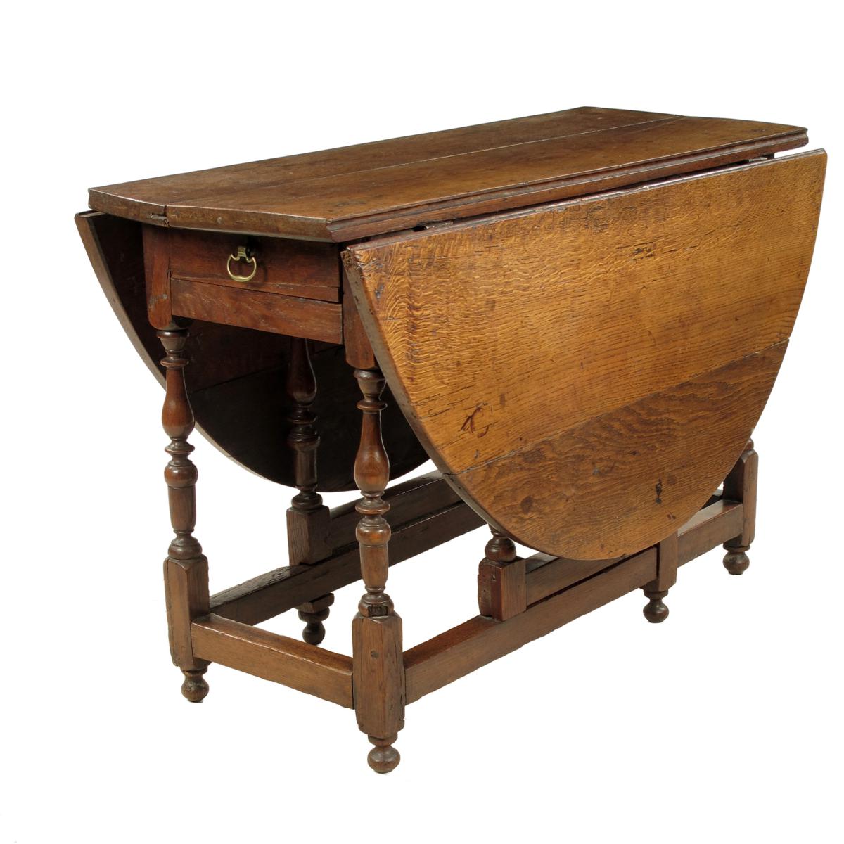 An oak gateleg table, with an oval top and an end frieze drawer, 18th century and later, 28?in (