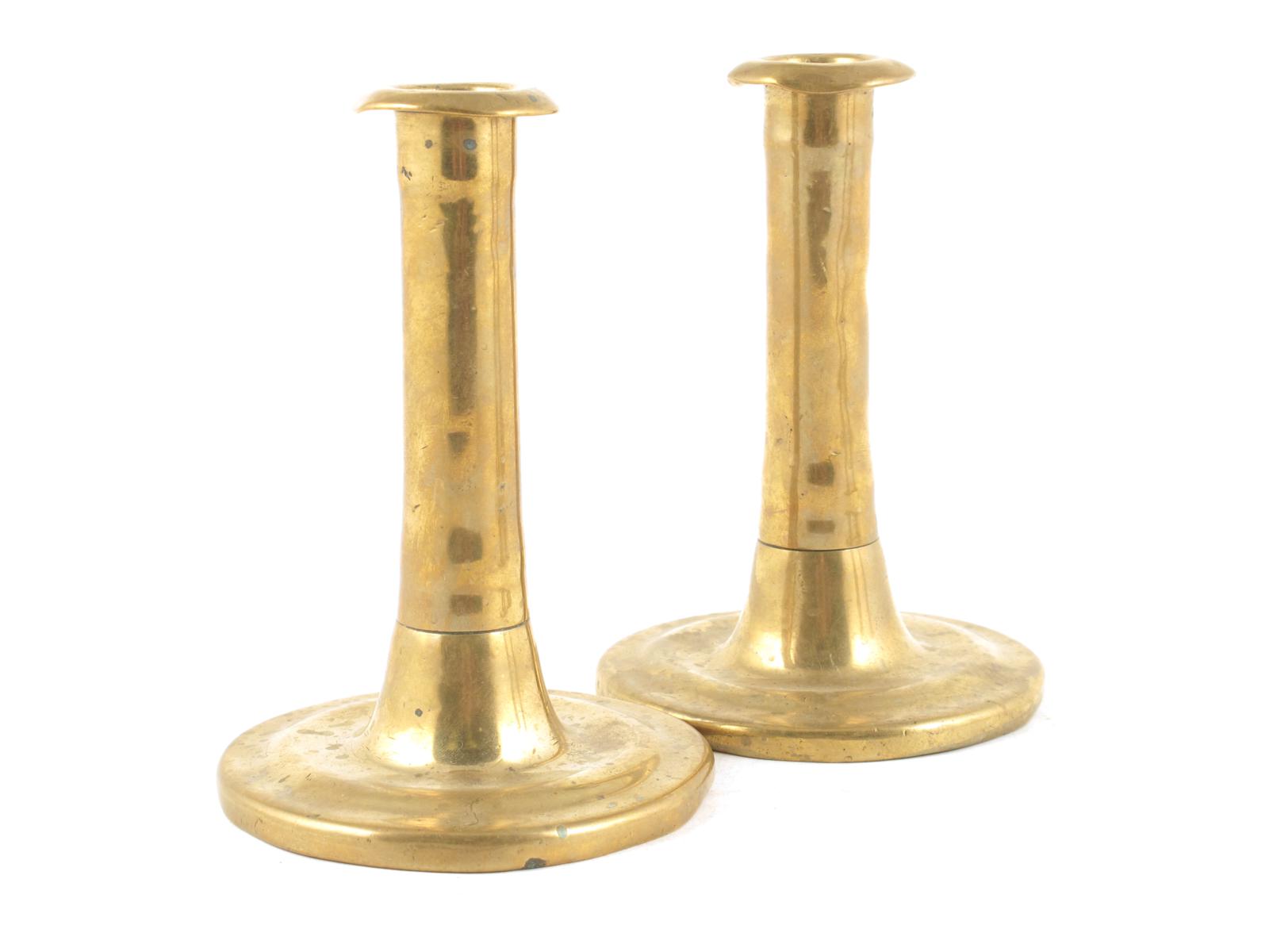 A pair of brass candlesticks, with ribbed stems, worn, late 17th / early 18th century, 5½in (13.8cm)