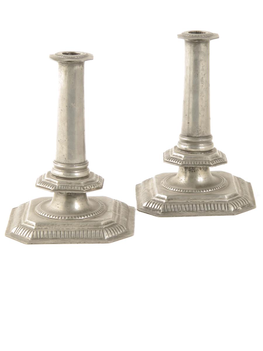 A pair of late 17th century style pewter candlesticks, each with a square base with canted corners