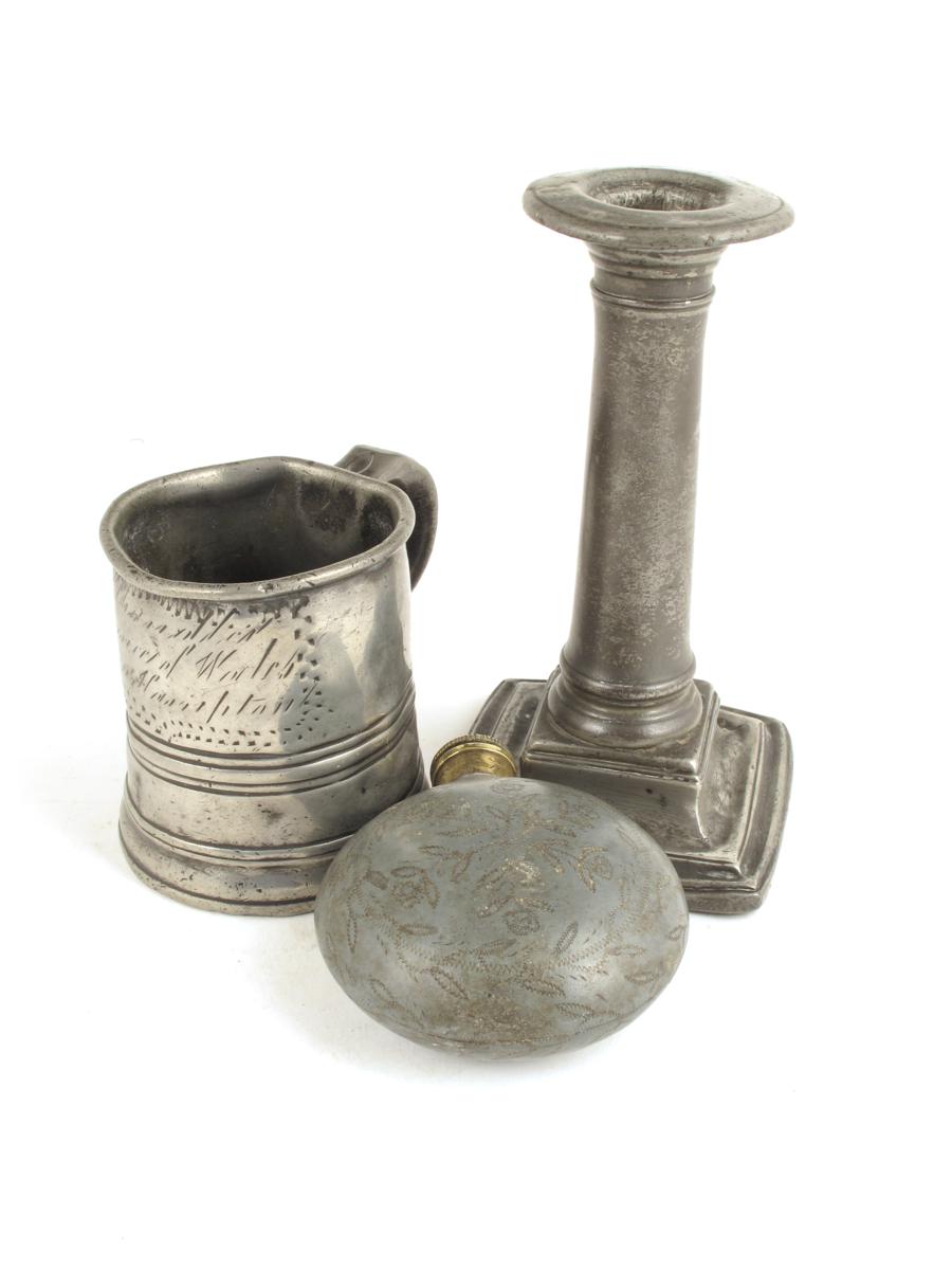 A pewter flask, with a brass mouthpiece and lid, with foliate wrigglework decoration, 3½in (8.9cm)