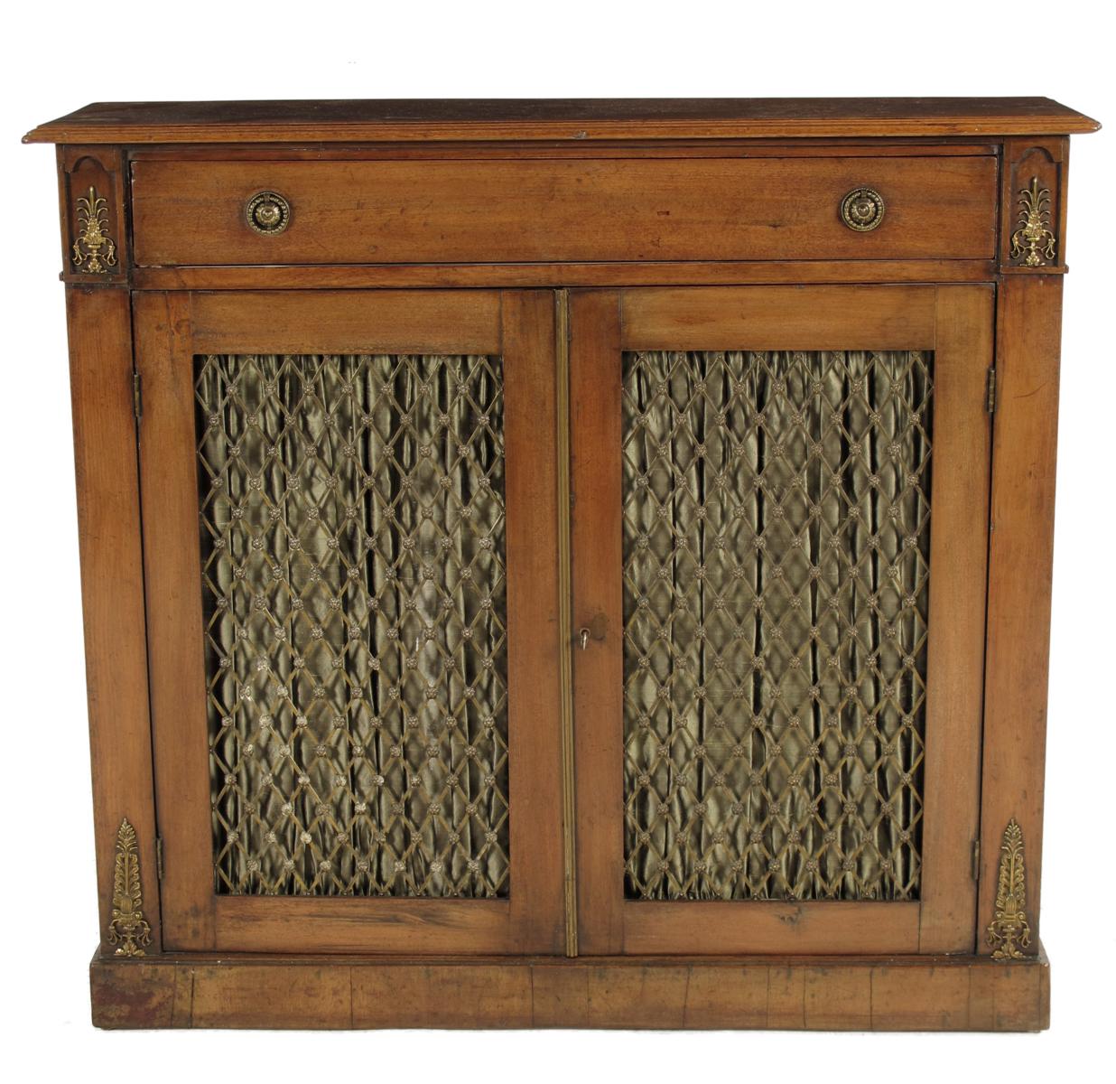 A mahogany side cabinet, in Regency style, with gilt metal mounts, with a pair of brass grille