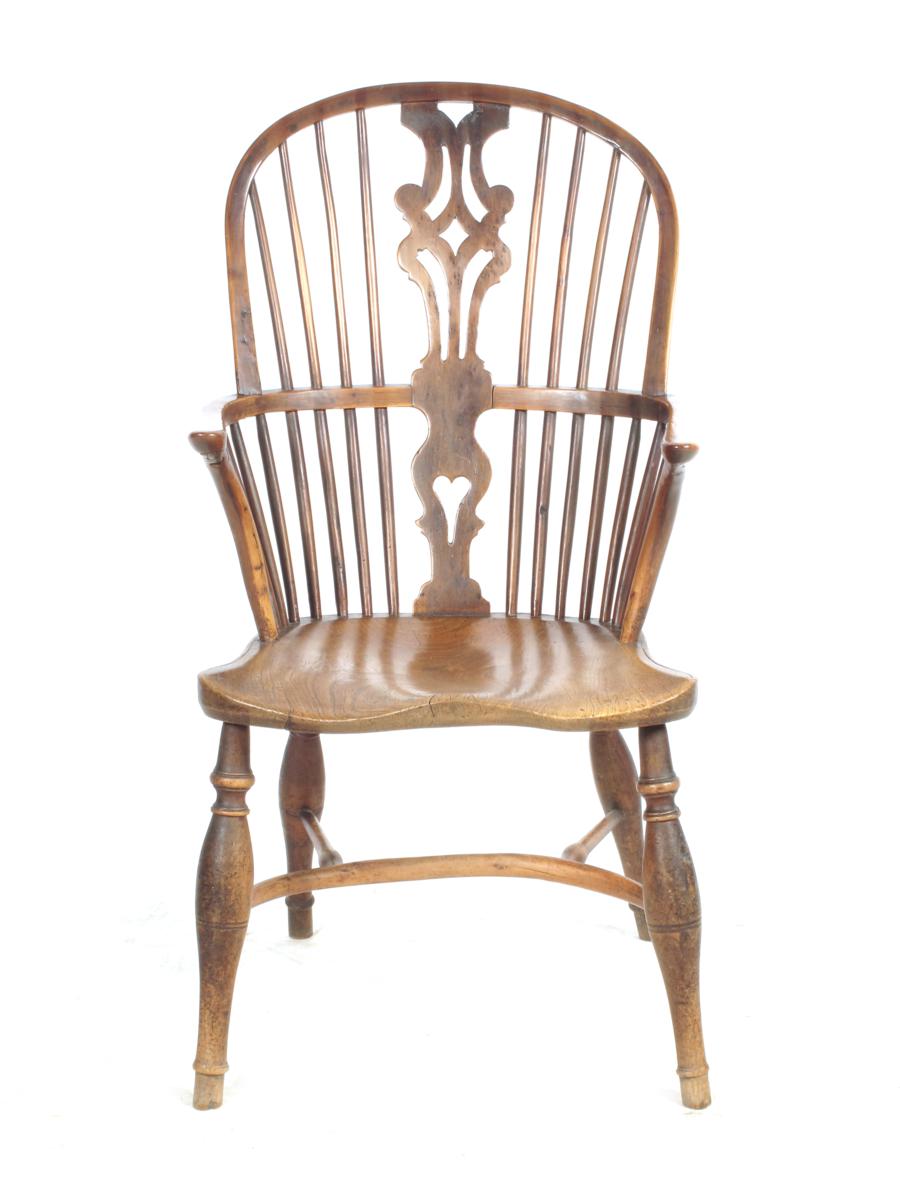 A 19th century yew high back Windsor armchair, with a pierced splat back, an elm seat and a