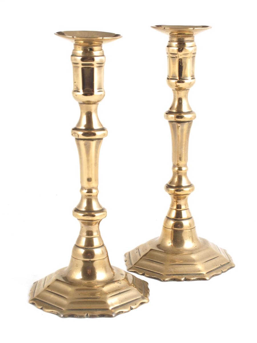 A pair of R?gence bell metal candlesticks, with detachable sconces, the underside of each marked `