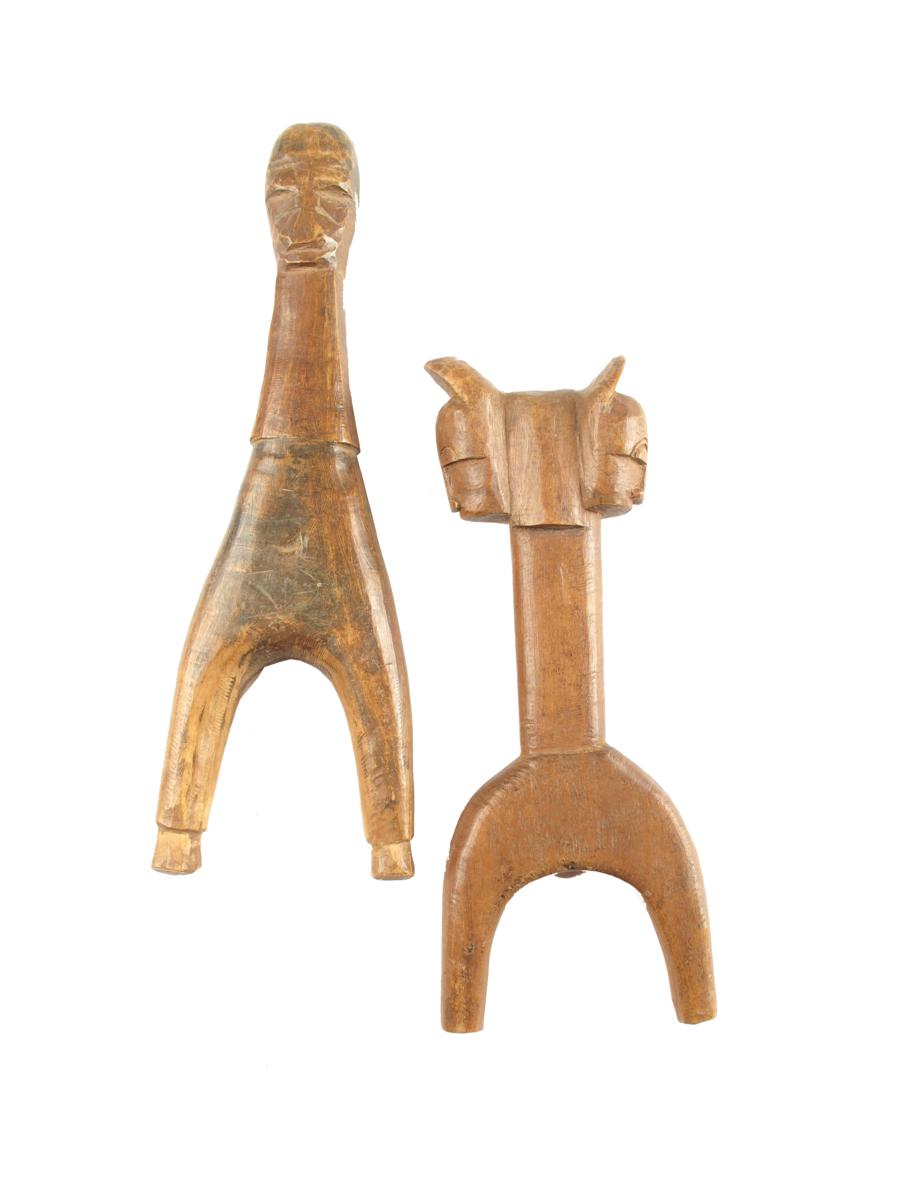 A Baule catapult, carved with two masks, 6?in (17.3cm) high and a Guro catapult, 8in (20.2cm)