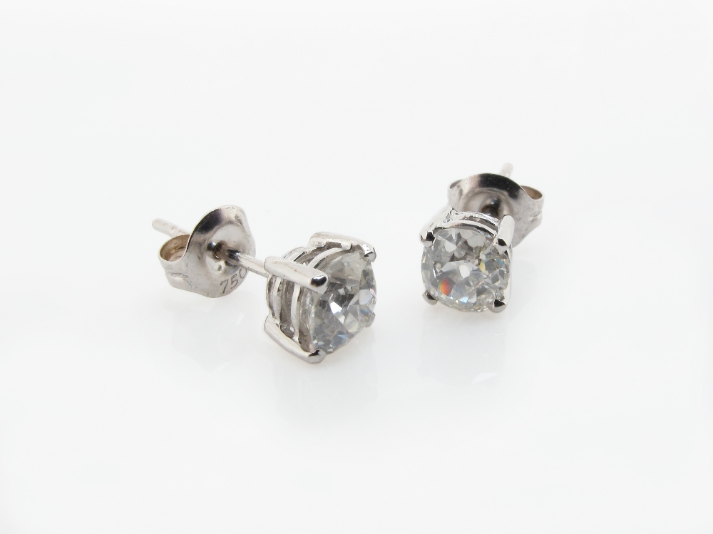 A pair of diamond stud earrings, the old cushion cut diamonds weigh approximately 1.50cts in total