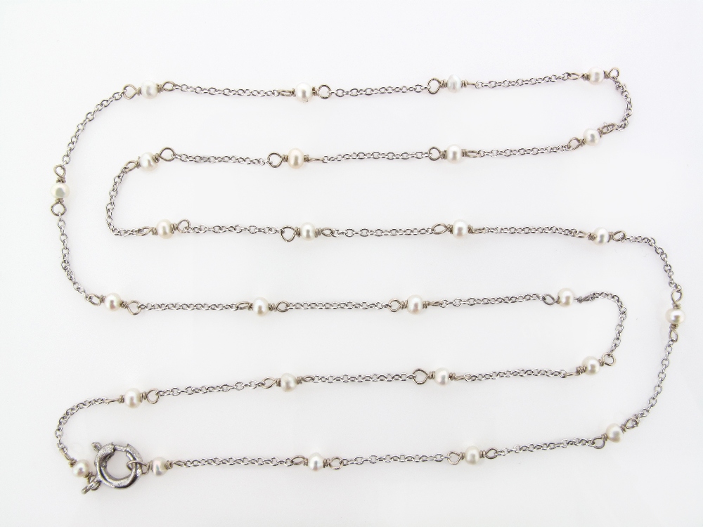 A fine link white gold neck chain, mounted with seed pearls. 50cm.