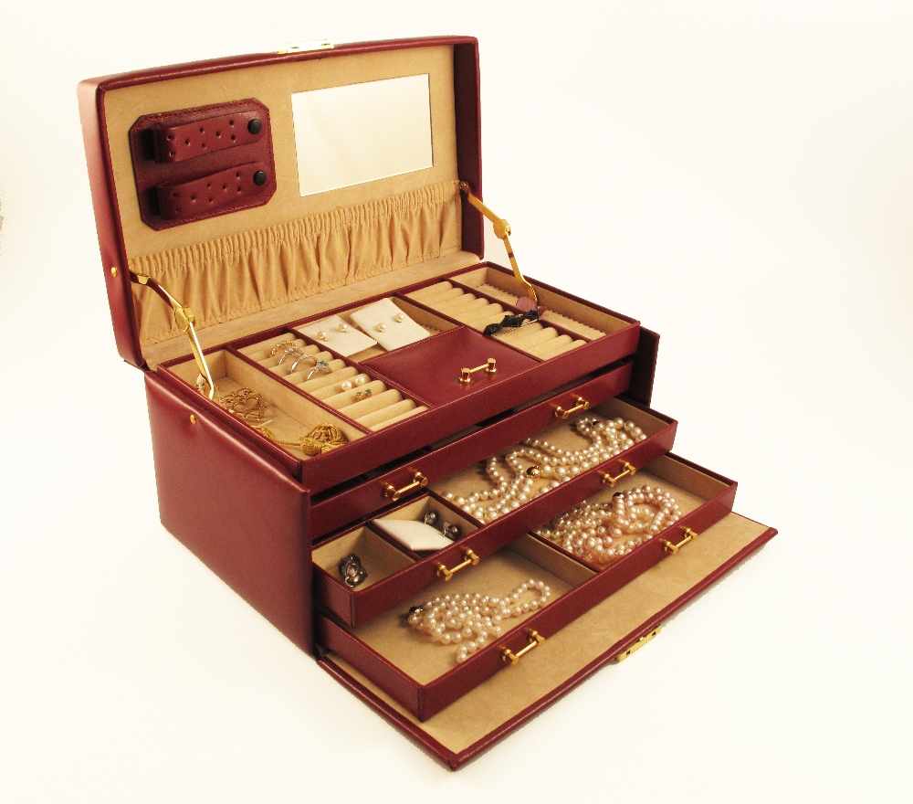 A jewellery box containing three diamond rings, six cultured pearl necklaces, nine pairs of assorted