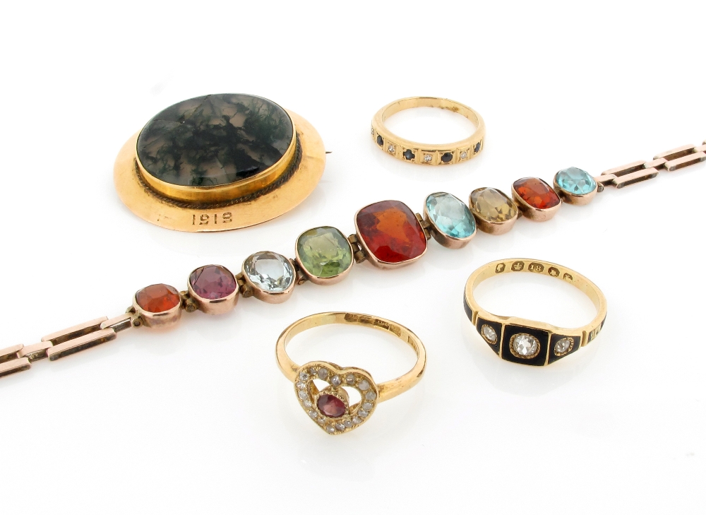A gold bracelet, mounted with assorted and graduated oval shaped coloured stones. A three stone