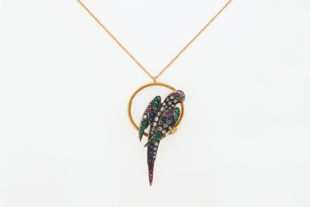 A gem-set parrot pendant, set overall with diamonds, rubies, emeralds and sapphires. Perched on a