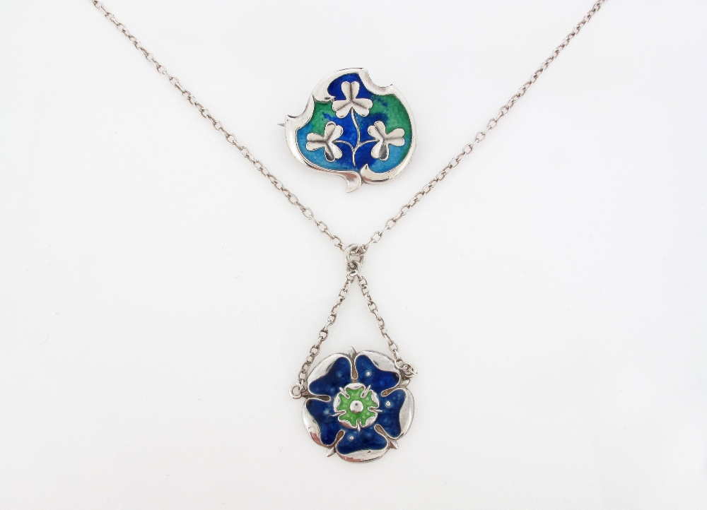 An Art Nouveau shaped silver brooch, designed as Shamrocks on a blue and green enamel ground.