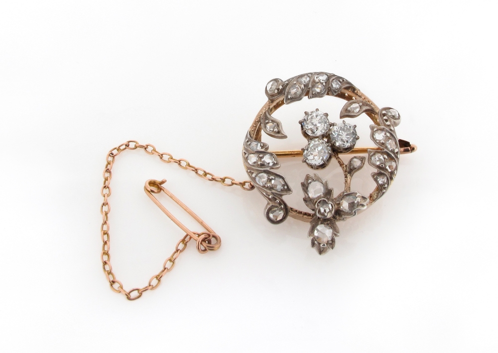 A Victorian diamond set circular floral brooch, centred with three old circular cut diamonds