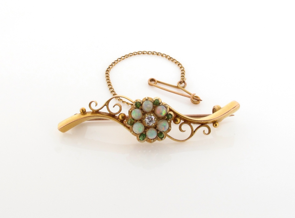 An Edwardian opal, demantoid garnet and diamond set gold scroll bar brooch. 4.5cm wide.