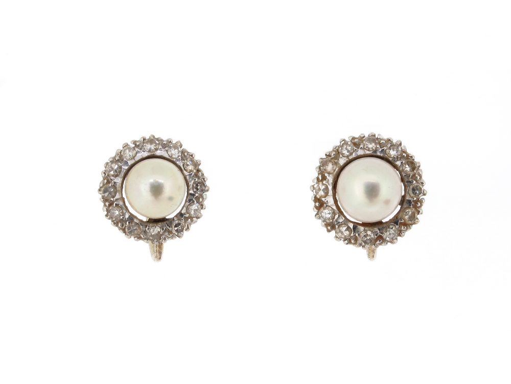 A pair of pearl and diamond cluster earrings, the untested pearls set within a surround of