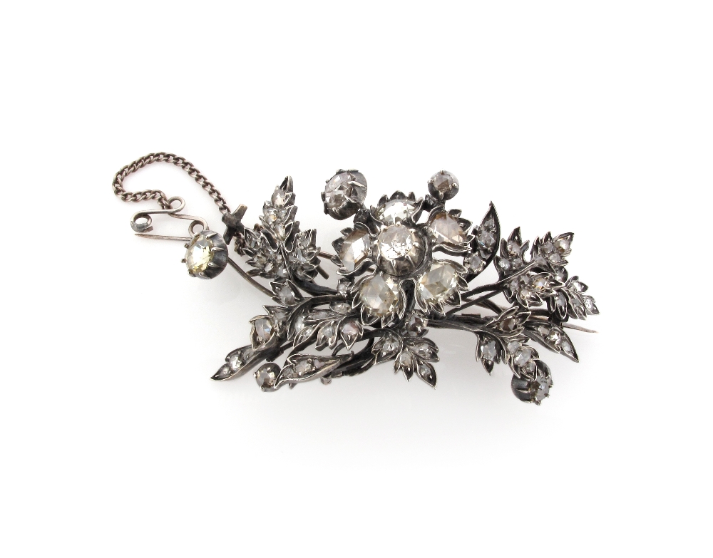 A 19th Century diamond set foliate brooch, the central cushion cut diamond set with further rose cut