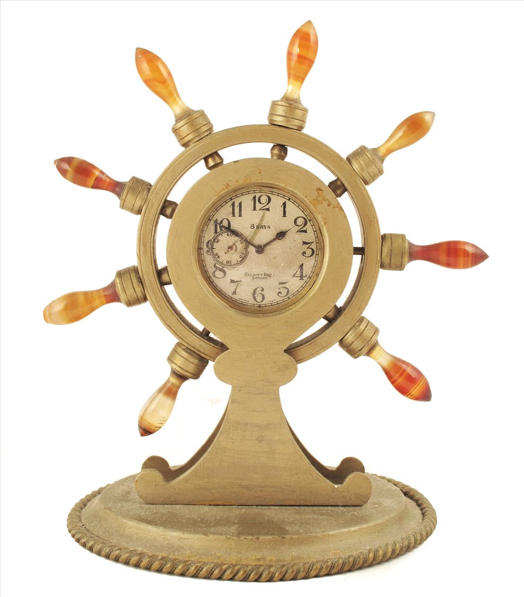 A mantel timepiece of ship`s wheel form, later Swiss eight day movement signed Elliott Bros,