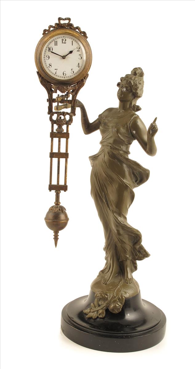 A spelter figural mystery clock, of a maiden wearing a billowing dress and supporting the white
