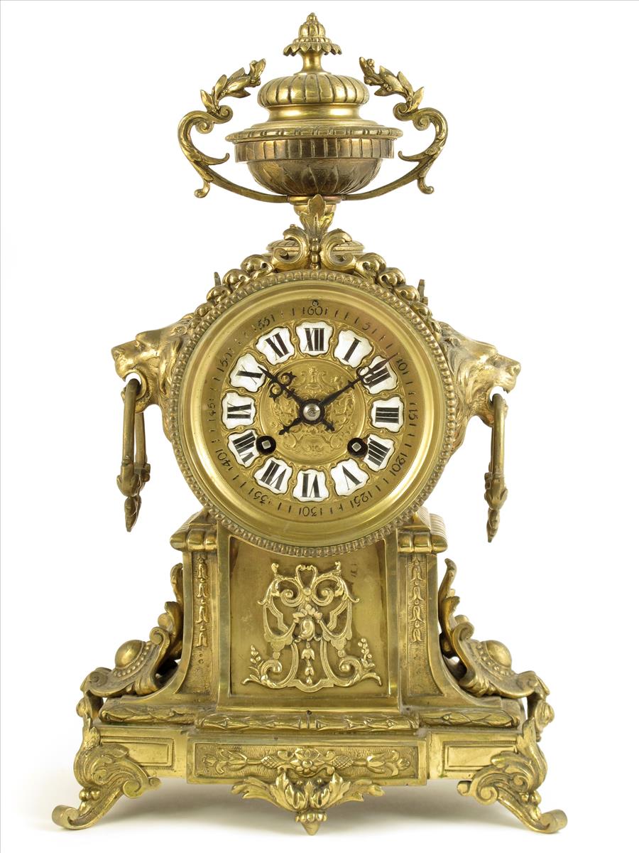 A French brass mantel clock, striking movement by Japy Freres, white enamel numeral reserves, in a