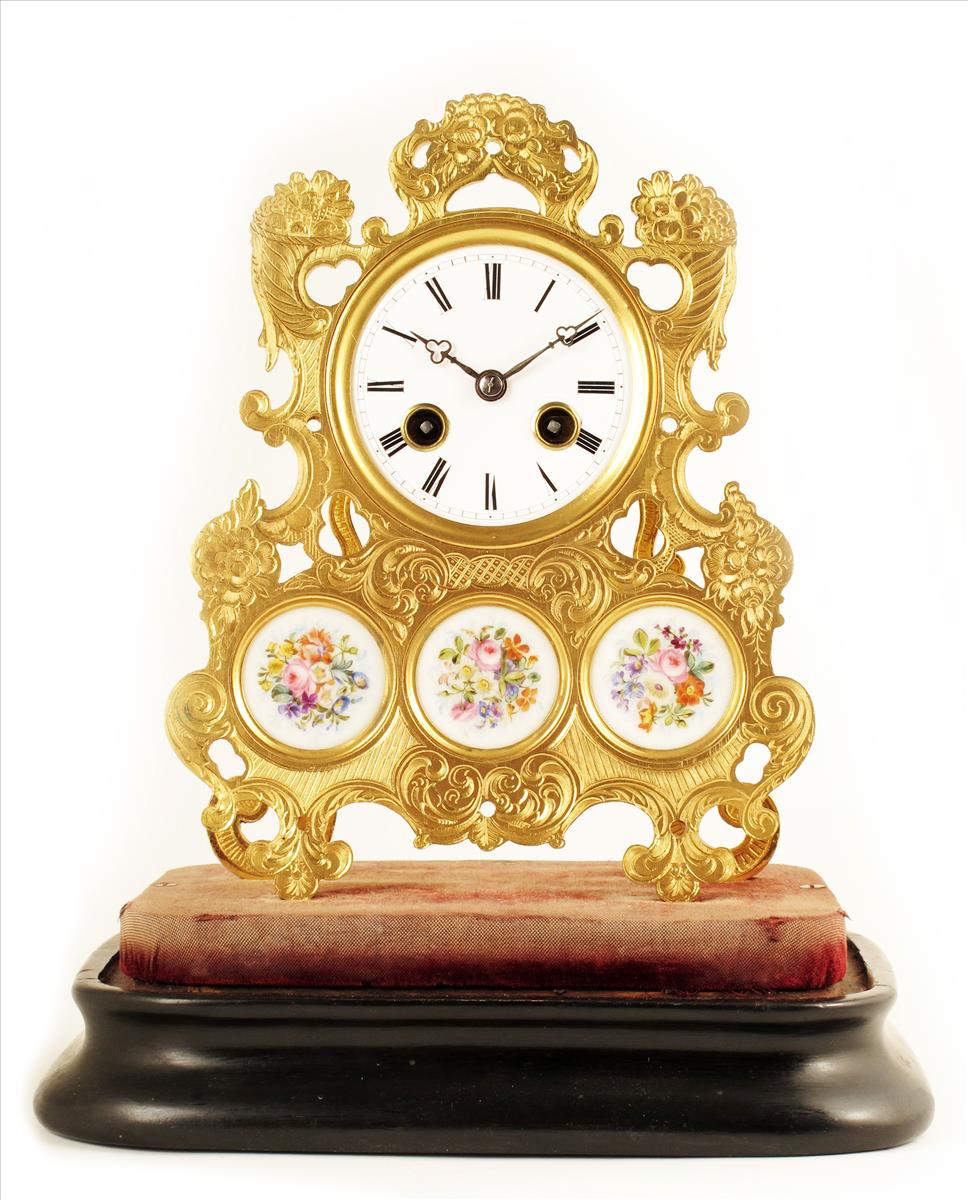 A French mantel clock, silk suspension movement stamped Hy. Marc, Paris, fitted into skeletonised