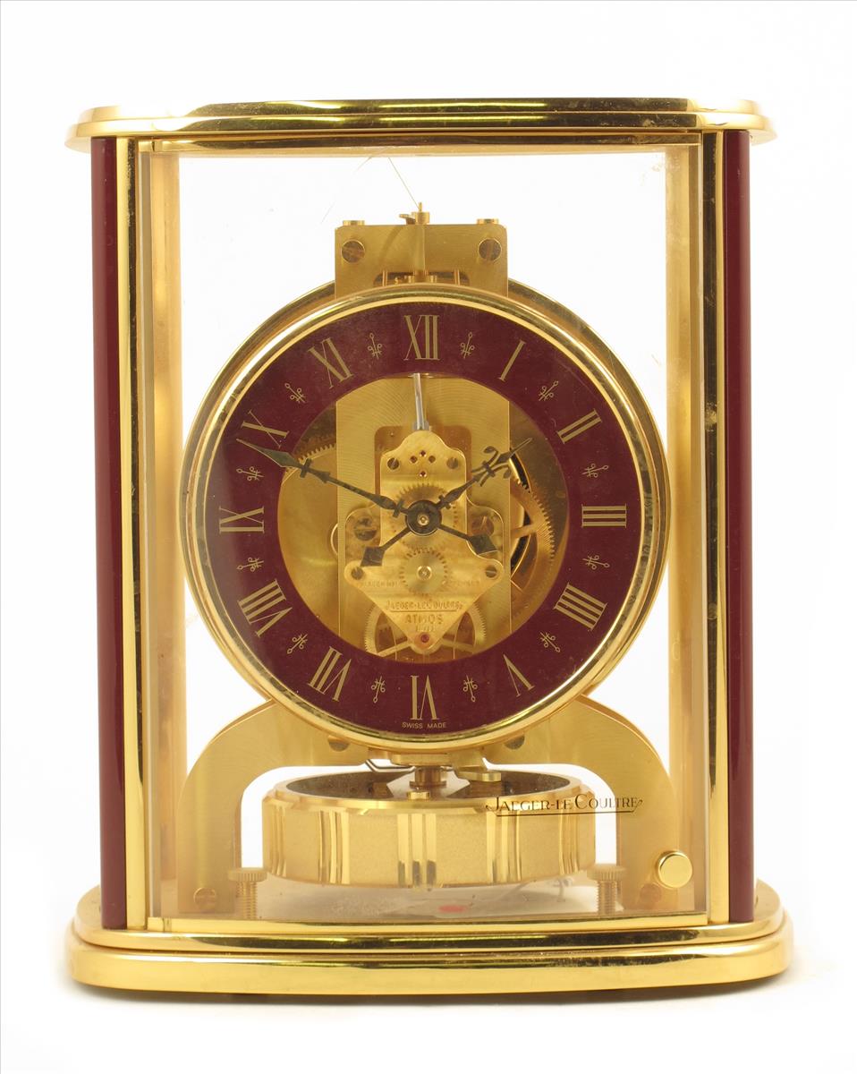 An Atmos timepiece, by Jaeger LeCoultre, no. 546664, maroon chapter ring, in a bow fronted case, the