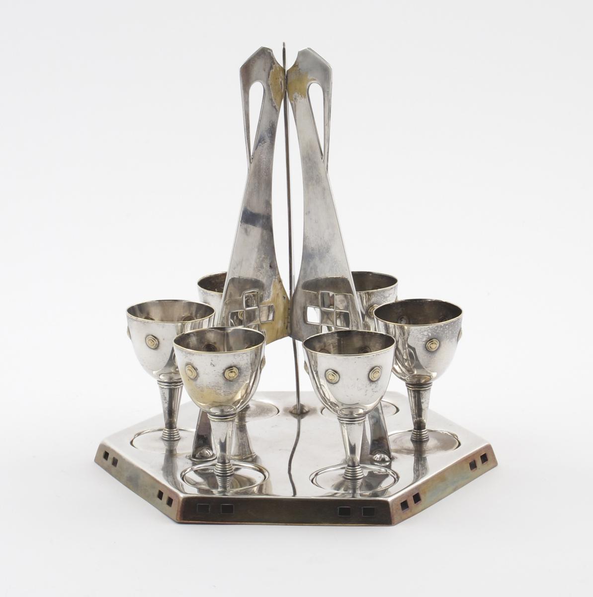 A W.M.F Secessionist electroplated egg tray and six cups, with pierced and stamped geometric
