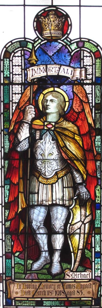 `St Michael` a large and impressive stained glass window, depicting the archangel resting, holding a