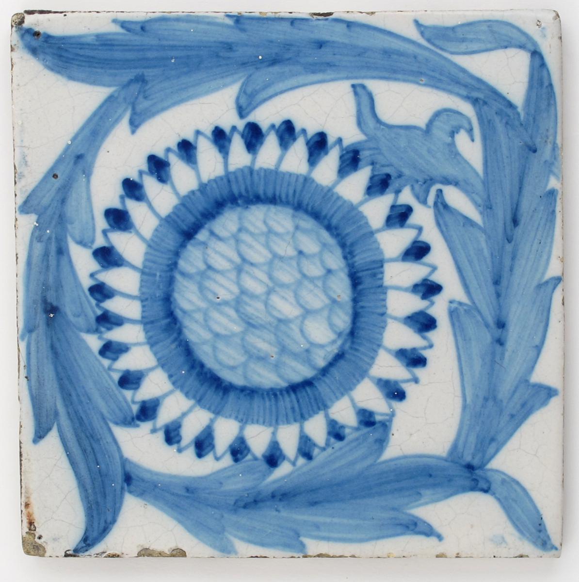 A Sunflower pattern Dutch tin-glazed tile designed by William De Morgan or William Morris,