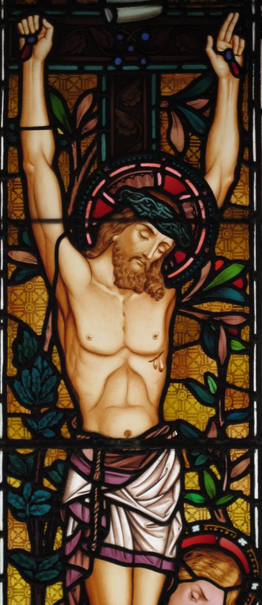 A large stained glass triptych window, in iron frames, the leaded windows depicting the