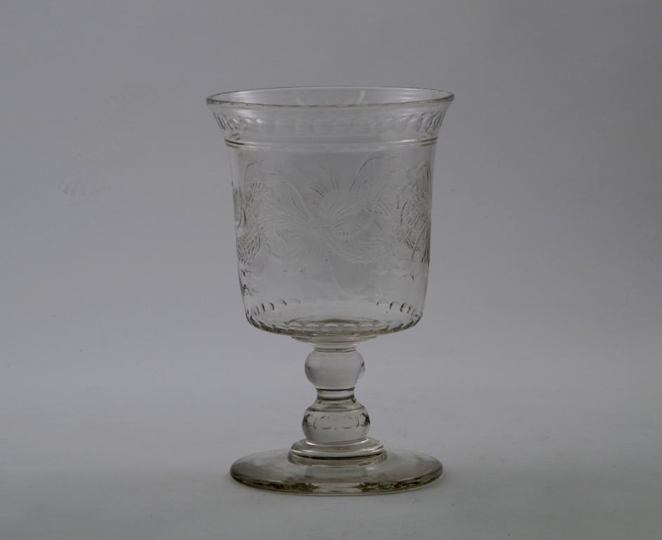 A large glass footed vase 19th century, engraved with a continuous garland design, the slightly