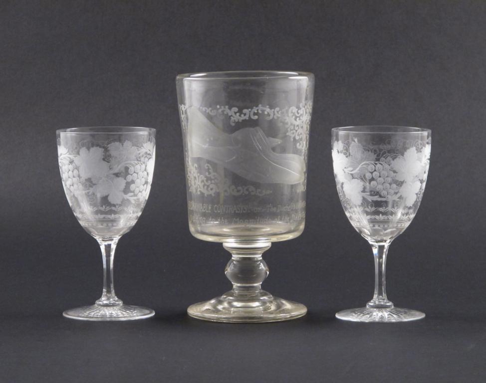 A large comical glass rummer and two goblets 19th century, the rummer engraved with a woman`s foot