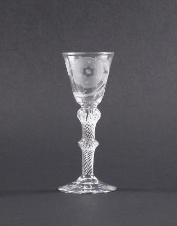 A Jacobite wine glass c.1760, engraved with a large six petal rose and single bud, raised on a