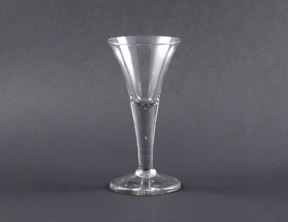 A large wine glass 18th century, the trumpet-shaped bowl rising from a thick plain stem, 20.3cm.