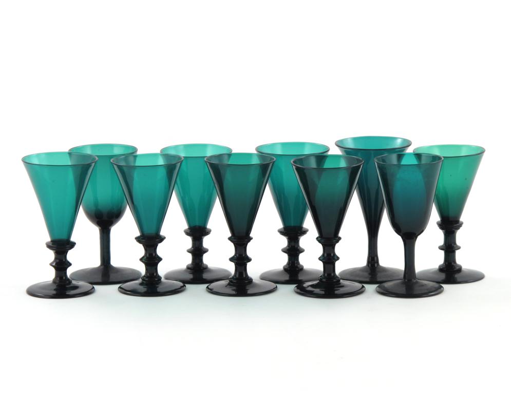 Ten green glasses 1st half 19th century, seven with flared trumpet bowls raised on double-knopped