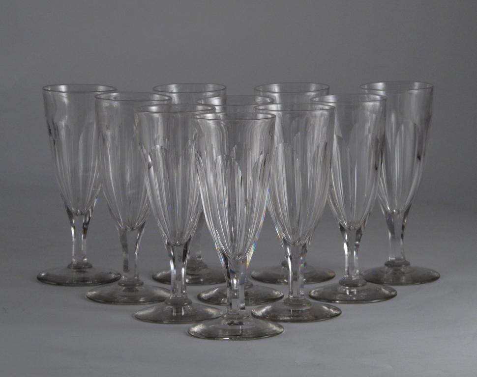 Ten glass flutes 19th century, the rounded conical bowls each cut with six long lappets and raised