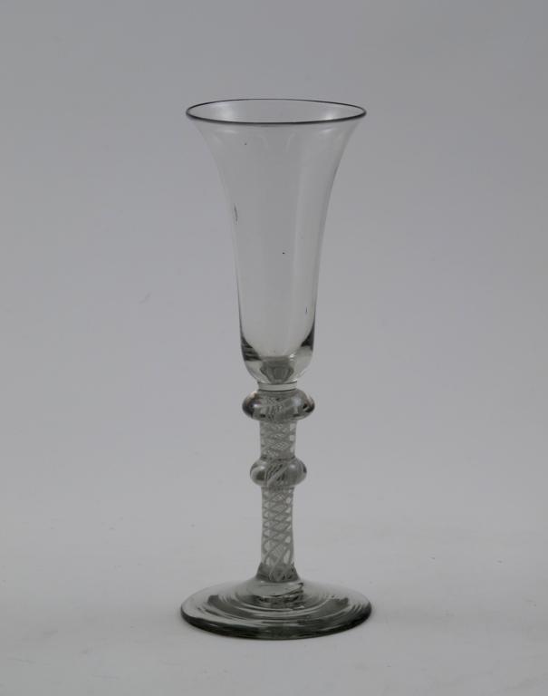 A tall wine glass, the flared bowl raised on a double-knopped opaque twist stem, 19.6cm.