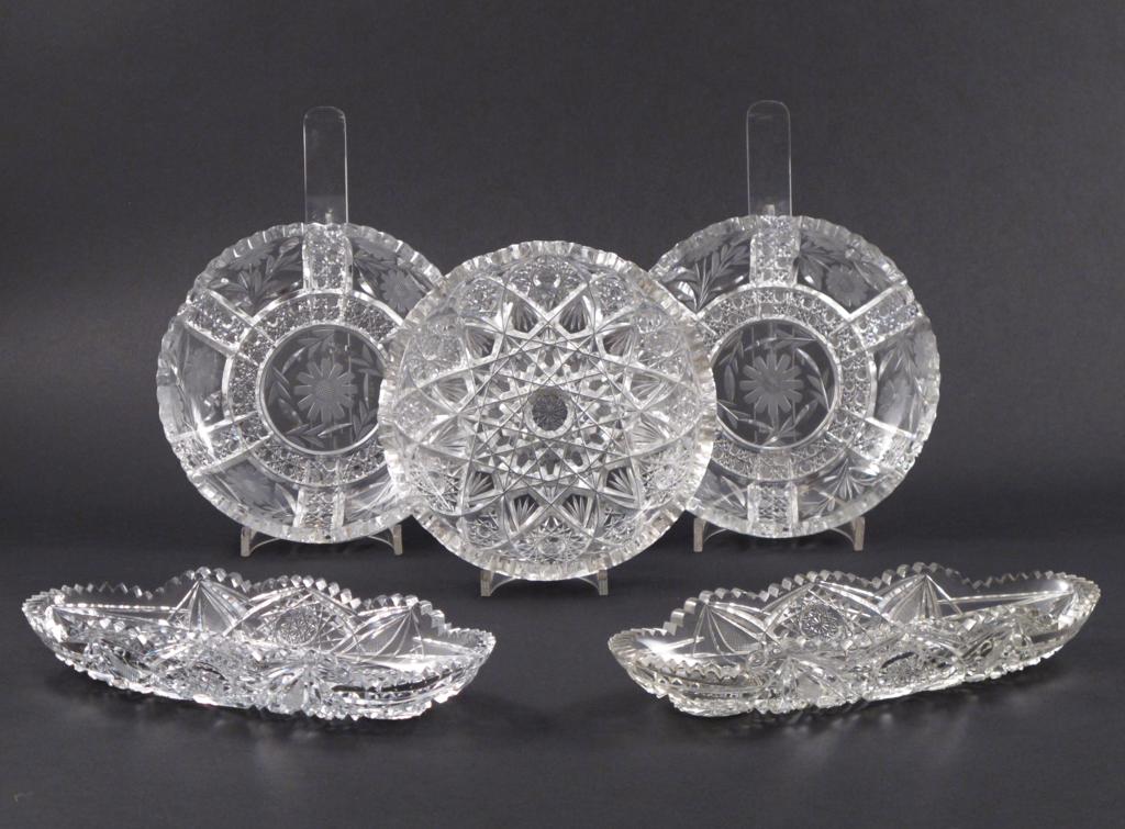 Two pairs of cut glass dishes, one pair of six-lobed form cut with panels of flowers, the other oval