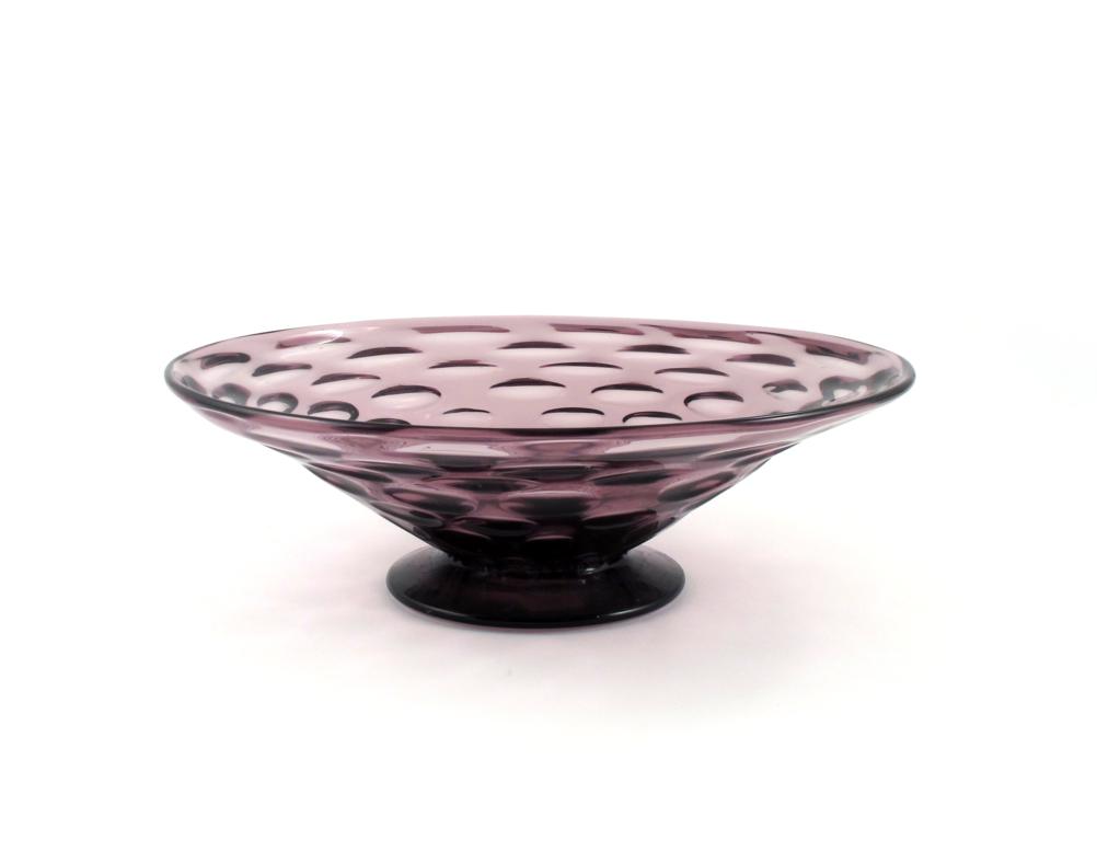 A large Whitefriars amethyst glass bowl 20th century, the shallow sides moulded to the exterior with