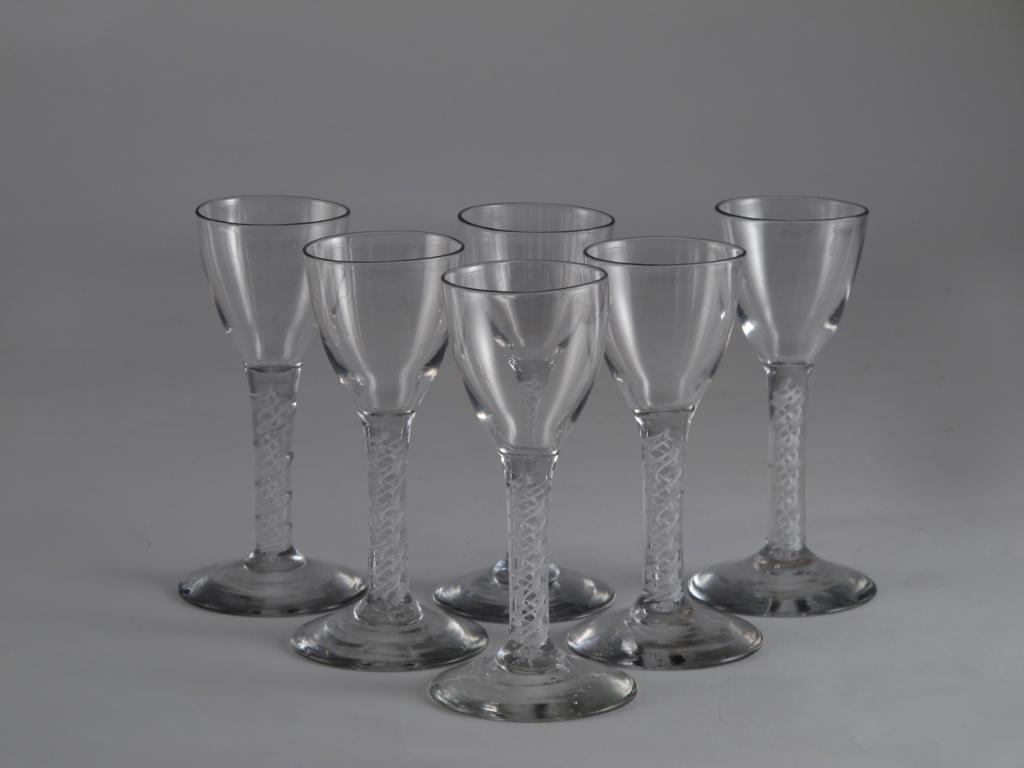 A set of six wine glasses late 18th century, with small bowls raised on double series opaque twist