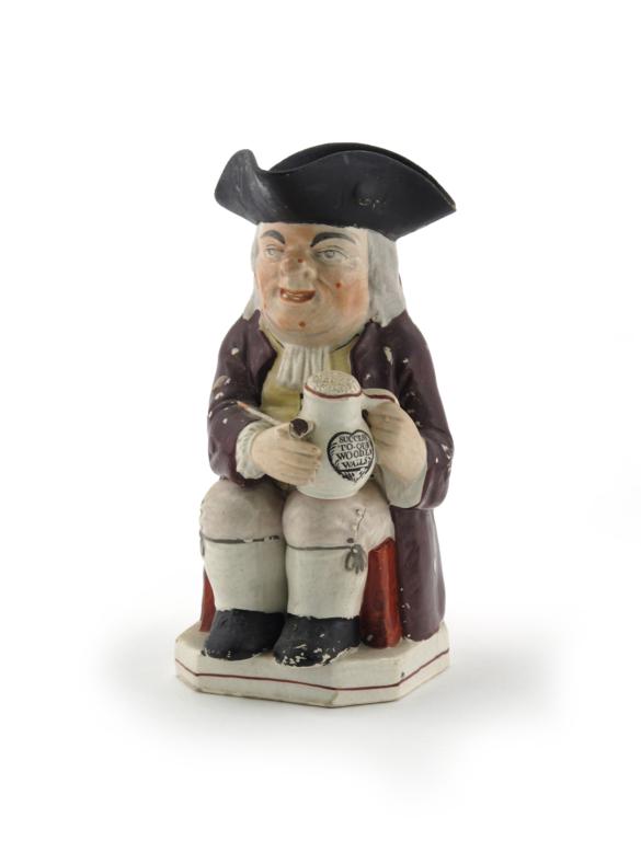 A `Success to our Wooden Walls` Toby jug c.1820, of Ordinary type, holding a long-stemmed pipe and