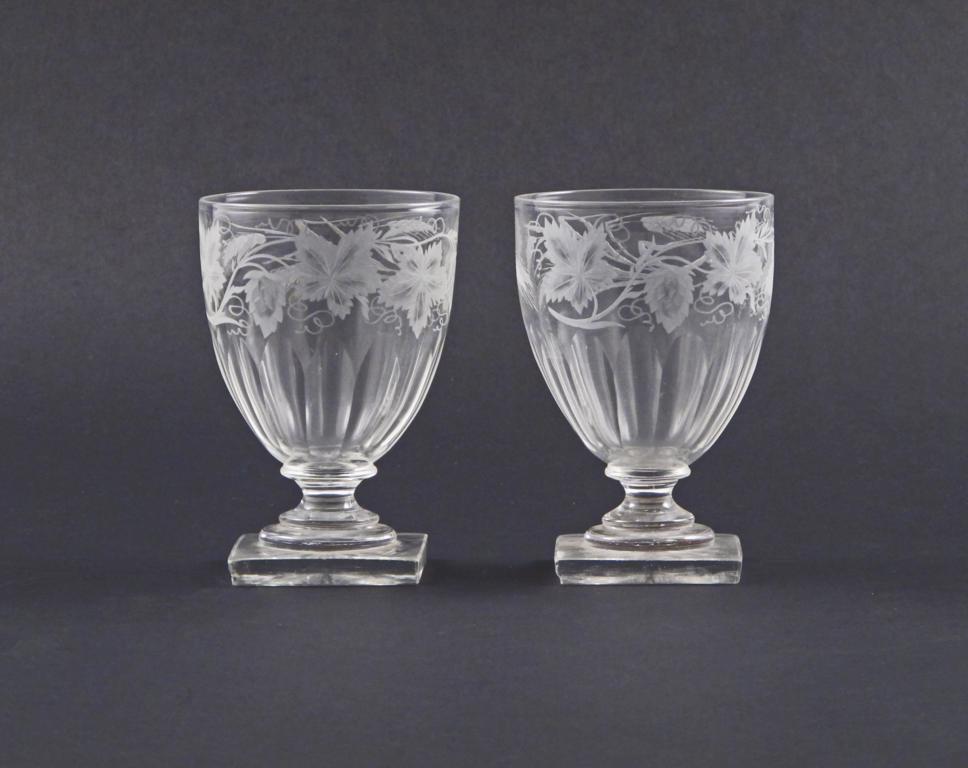 A pair of rummers 19th century, engraved with hops and barley above polished lappets, raised on