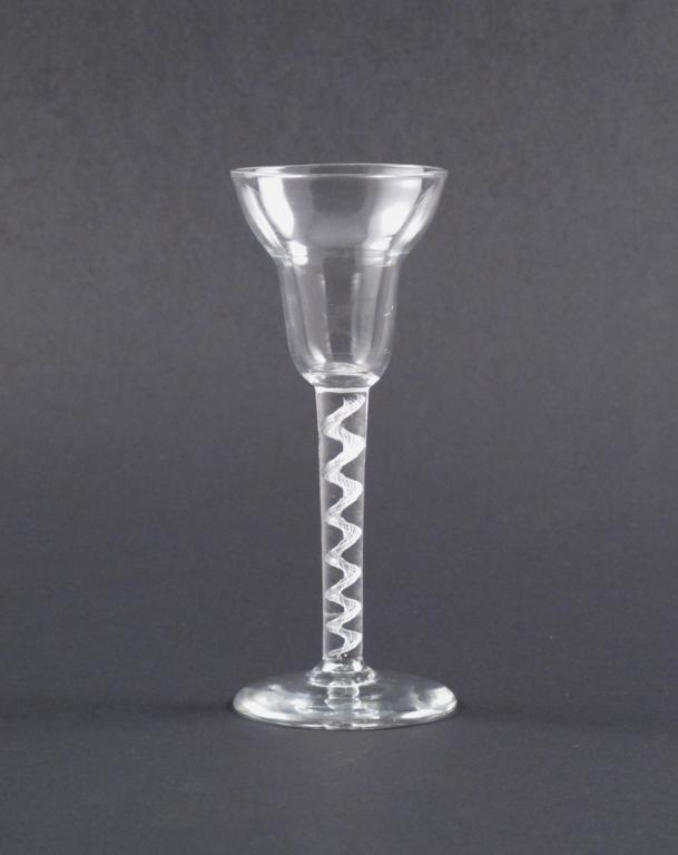 A pan-topped wine glass c.1760, raised on an airtwist stem above a thick foot with a slight step,