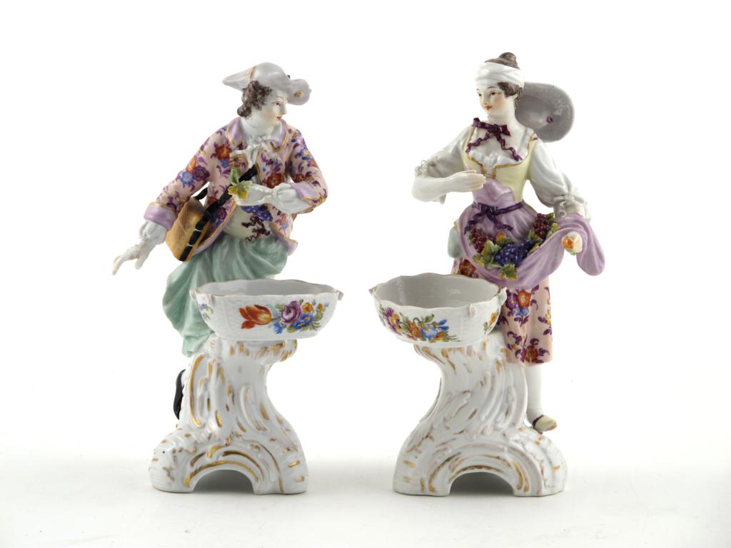 A pair of Berlin sweetmeat figures 19th century, each modelled as a vintner with bunches of