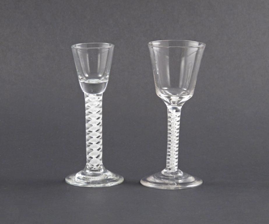 A cordial and a wine glass mid 18th century, both raised on double series opaque twist stems, the