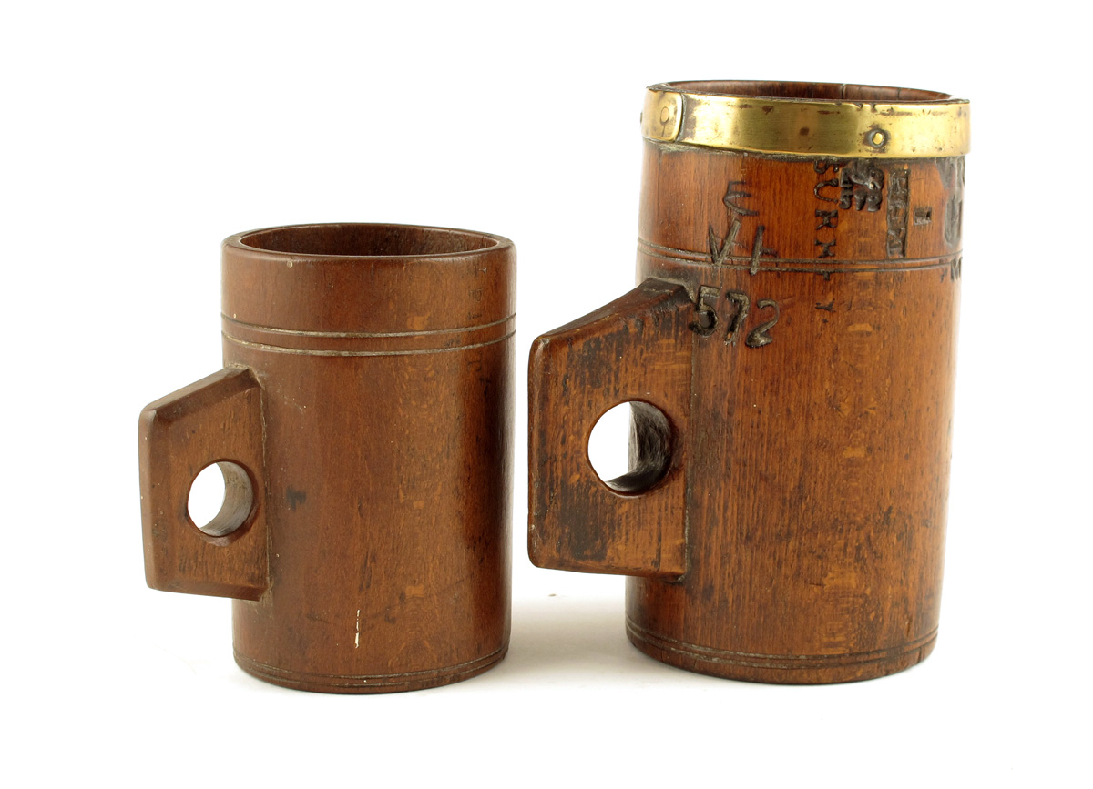 Two Victorian beechwood measures, the pint measure with a brass rim and branded with letters and