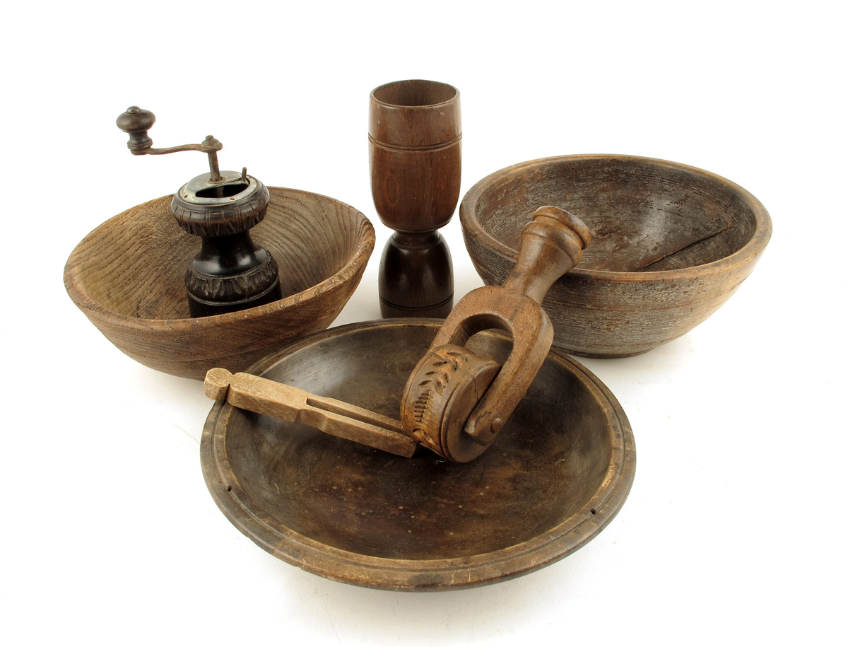 A small collection of treen, to include: three bowls, a grinder, a peg, a butter roller and a double