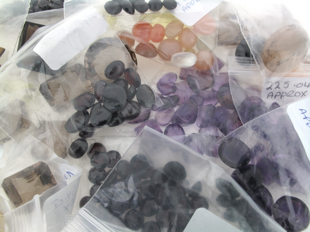 Assorted gem stones, including amethysts, two large and four smaller green quartz, a large emerald