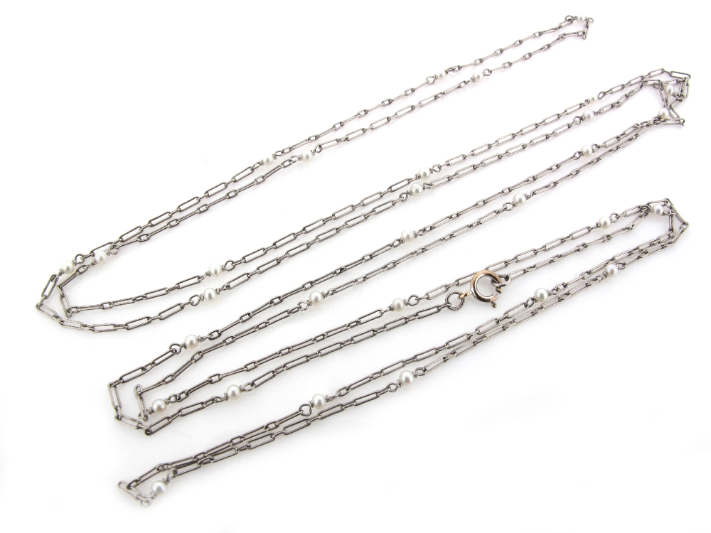 A fine link white gold neck chain, set with seed pearls. 39cm.